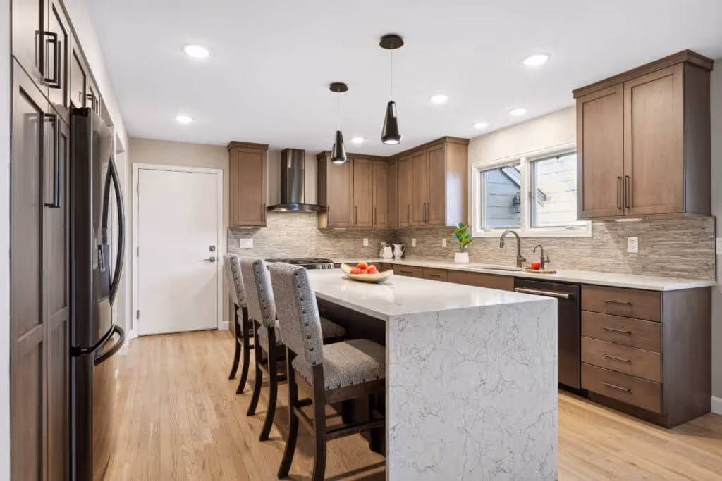 Elegant dining area with a modern light fixture and wainscoting on the walls.