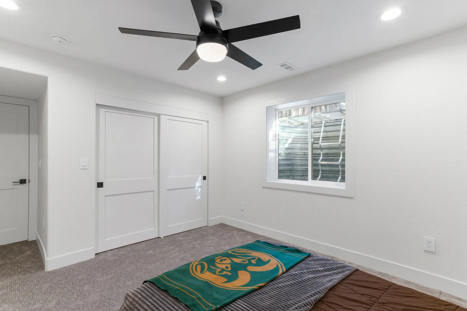 Guest bedroom and walk-in closet in a finished Littleton basement