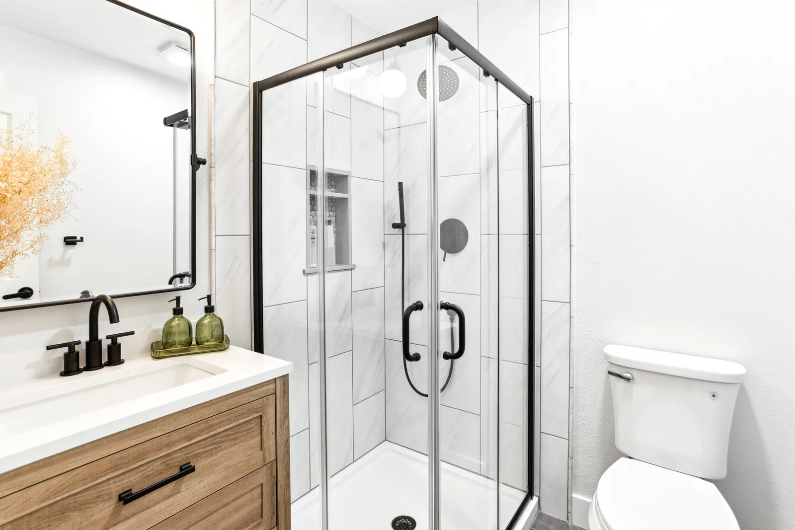 Englewood guest bathroom remodel with oak vanity and glass shower