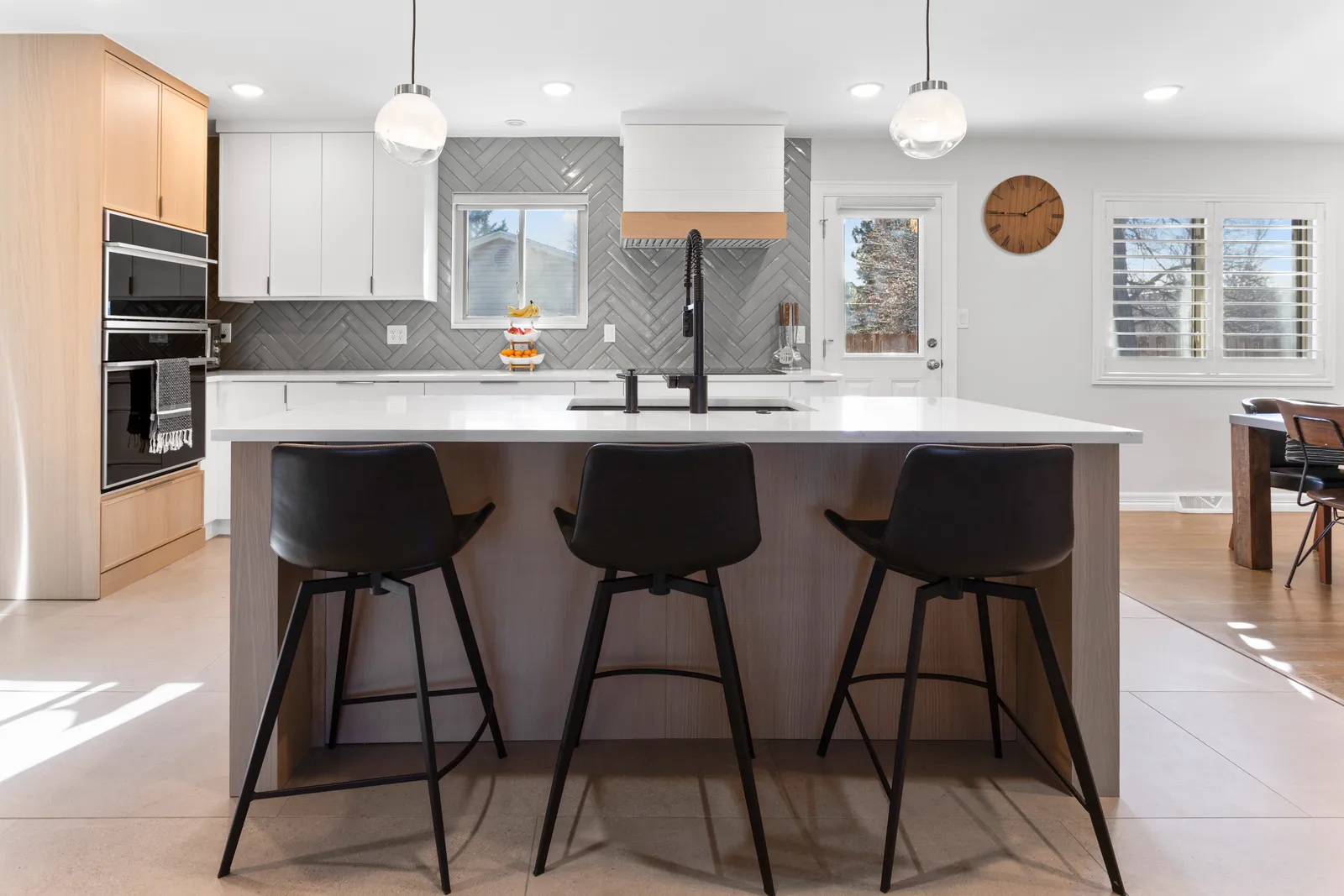 Quartz island with bar seating and matte black faucet, Cherry Knolls kitchen remodel
