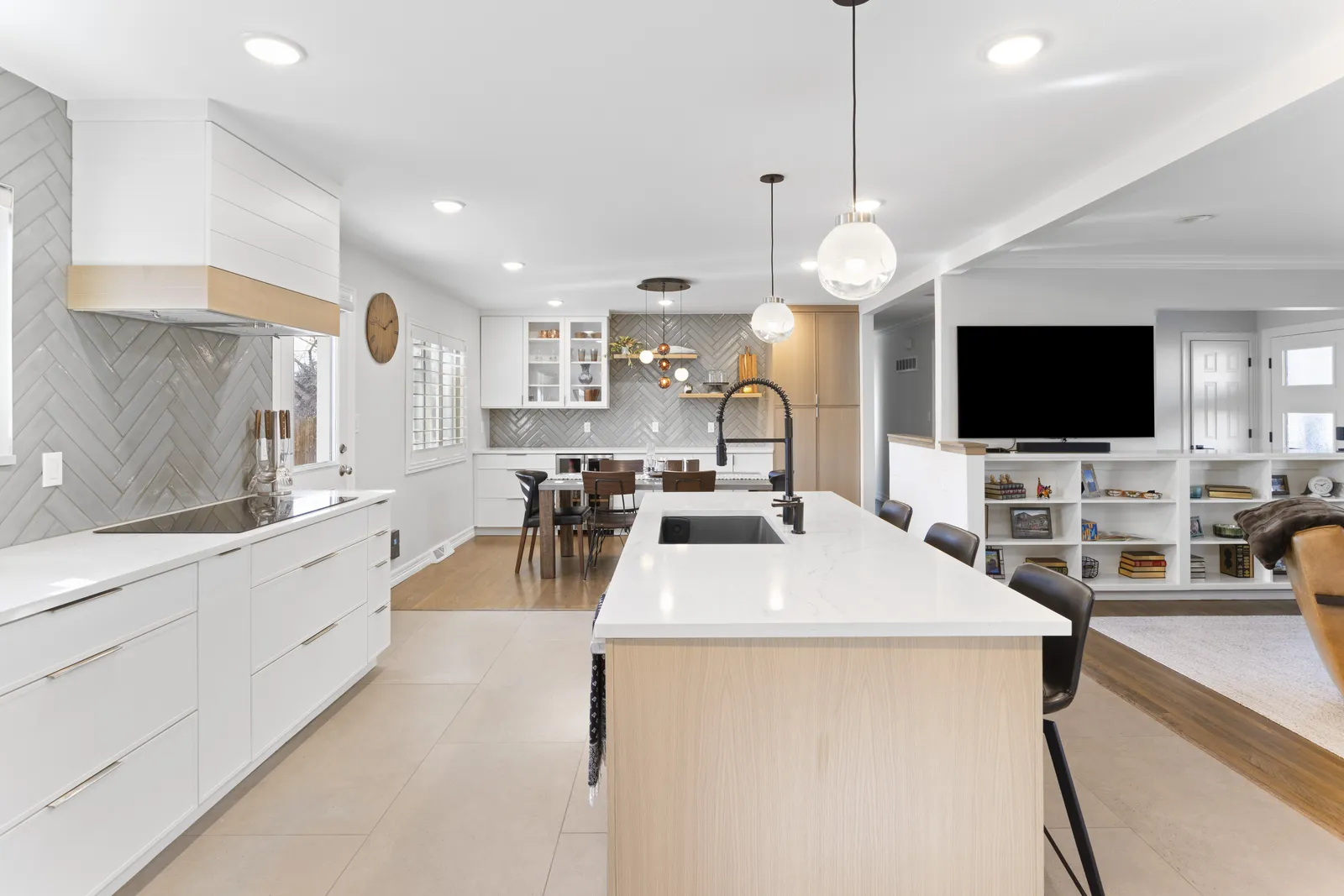 Herringbone tile backsplash and custom hood in a remodeled Centennial kitchen