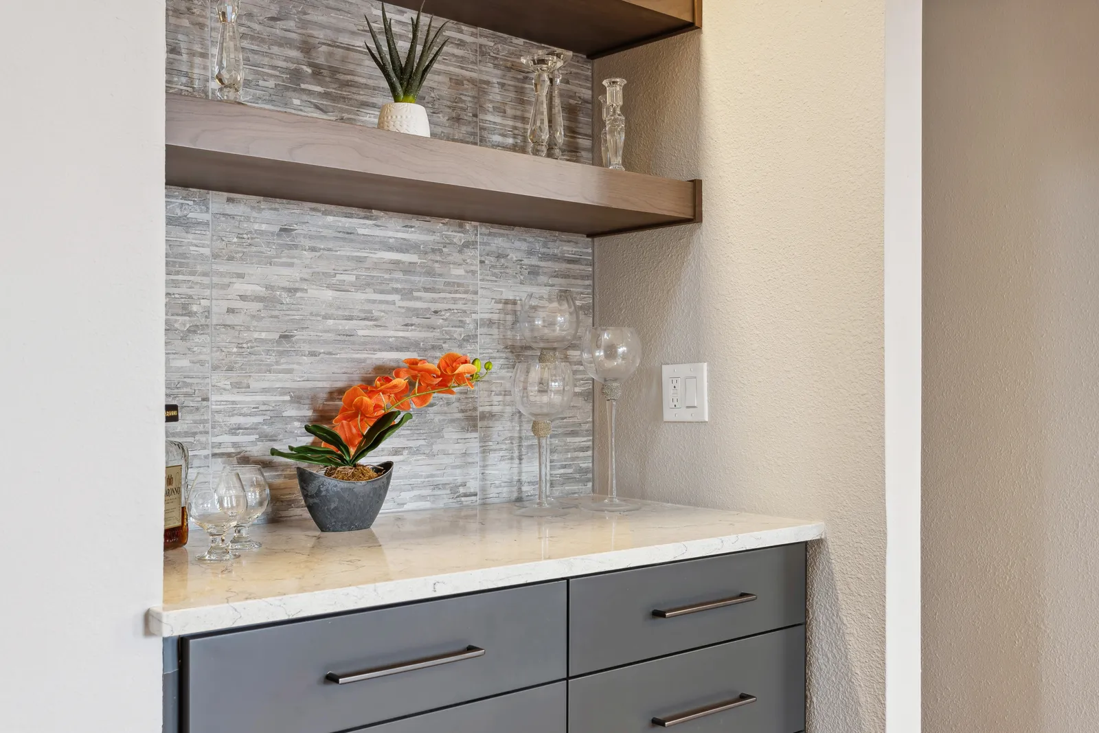 Dry-bar nook with floating shelves and stone tile, Denver kitchen remodel