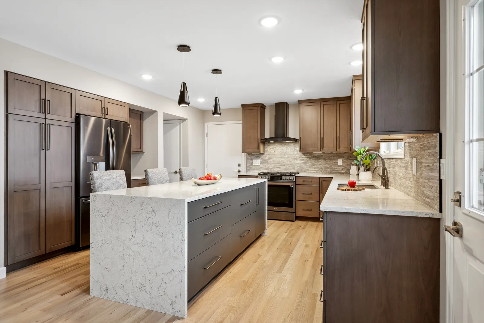 Warm wood kitchen open to dining area, Denver Tech Center remodel