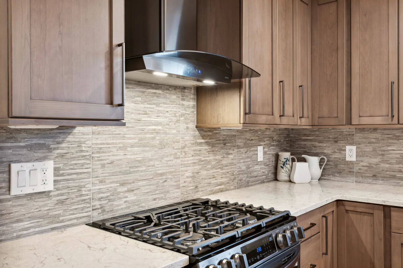 Stainless chimney hood over gas range, Denver Tech Center kitchen