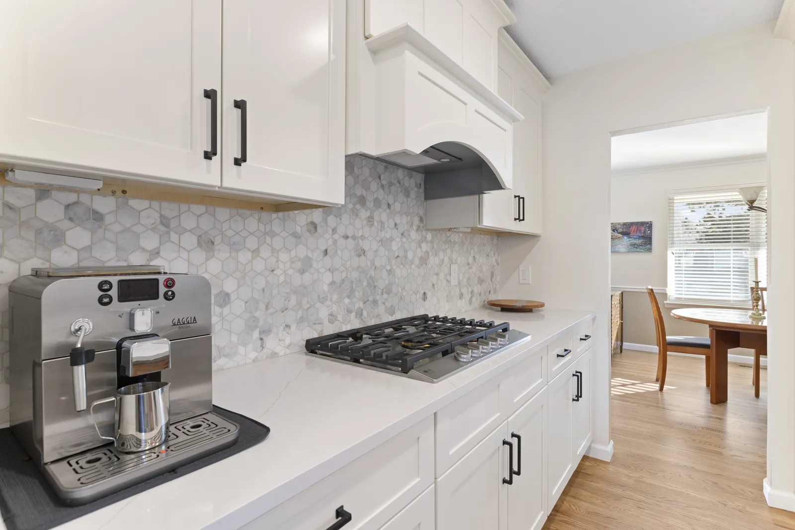 Hexagon marble backsplash and gas cooktop in an Englewood kitchen