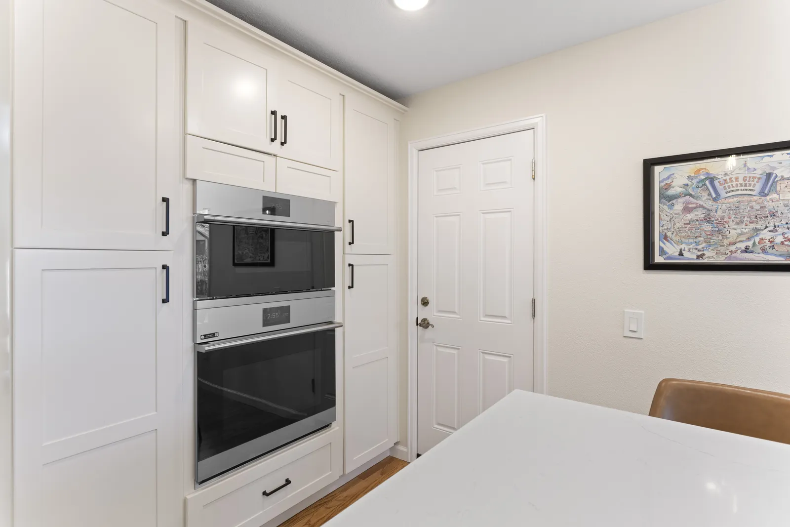 White shaker cabinets with built-in wall ovens, Englewood remodel