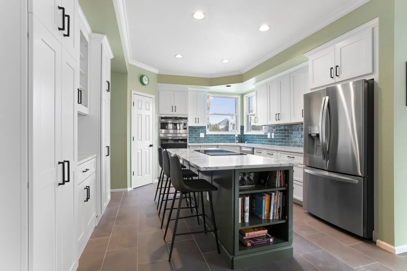 Highlands Ranch kitchen remodel with white cabinets and sage green island