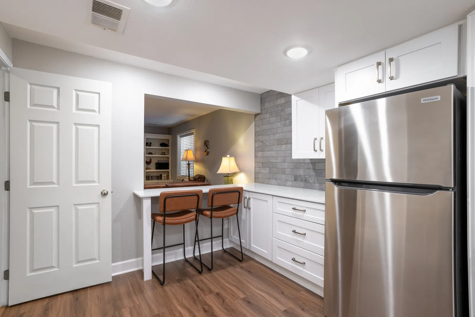 Basement kitchenette with white cabinets and quartz counters, Centennial CO