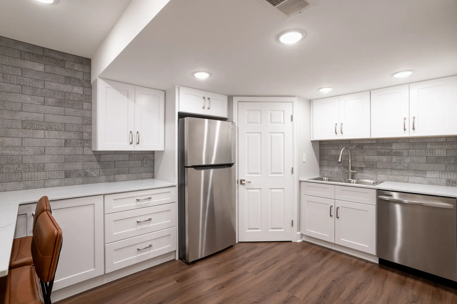 Basement wet bar kitchenette with stainless fridge, Centennial remodel