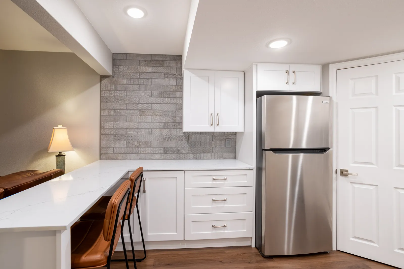 Pass-through bar with stools into a rec room, Centennial kitchenette