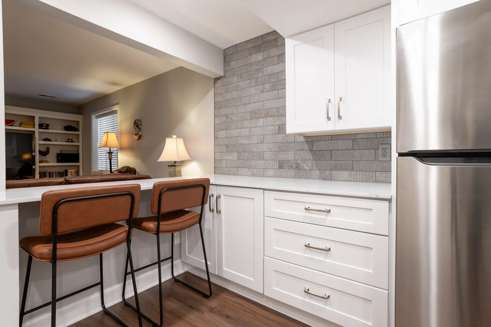 Basement kitchenette with counter seating, Centennial remodel