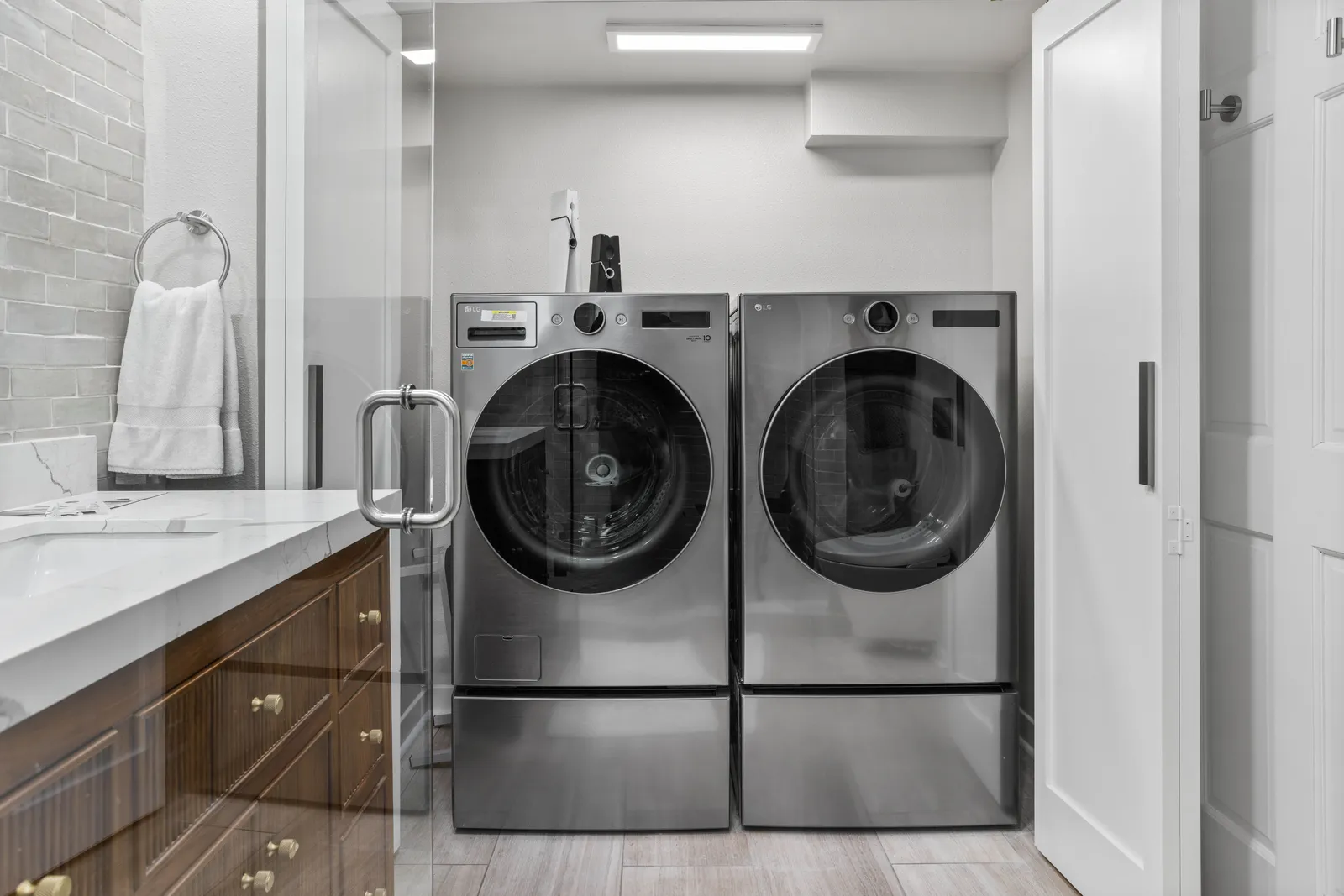 Full-size stainless washer and dryer in a remodeled Centennial laundry room