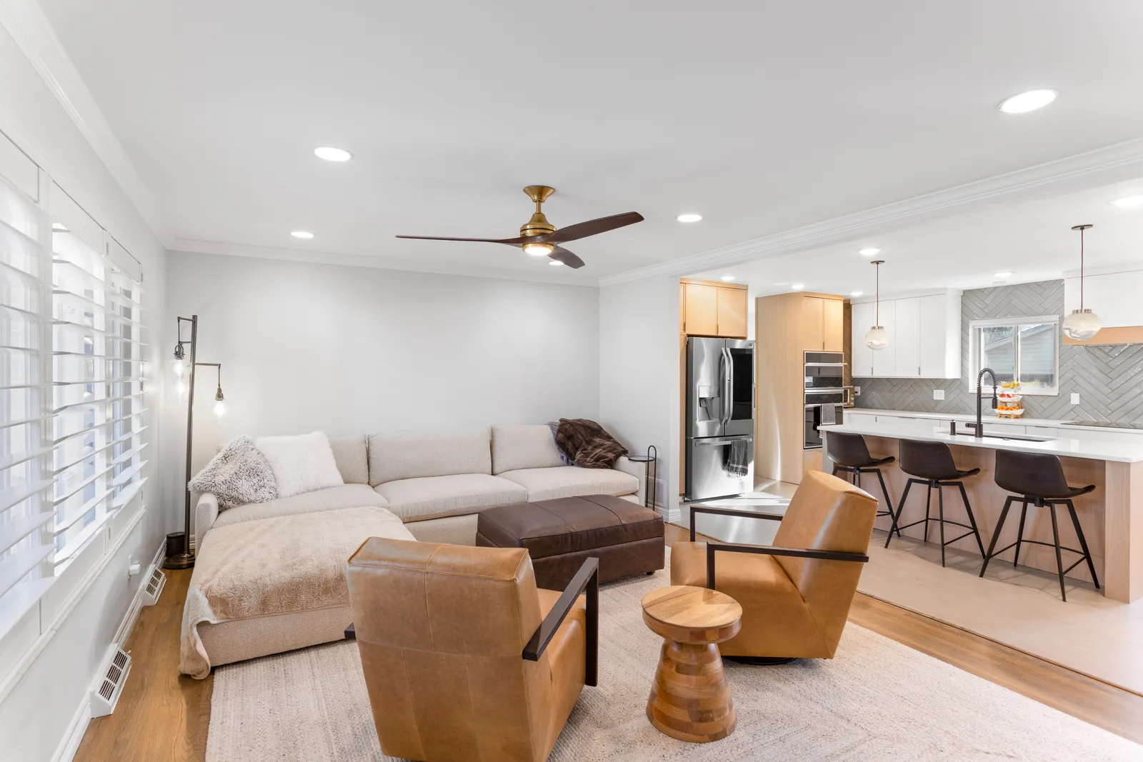 Living room with leather chairs open to kitchen, Cherry Knolls remodel