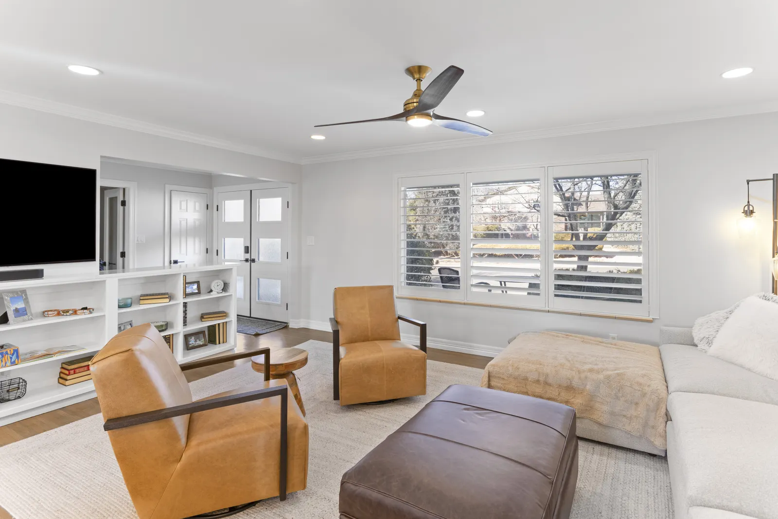 Built-in media wall with shelving in a remodeled Centennial living room