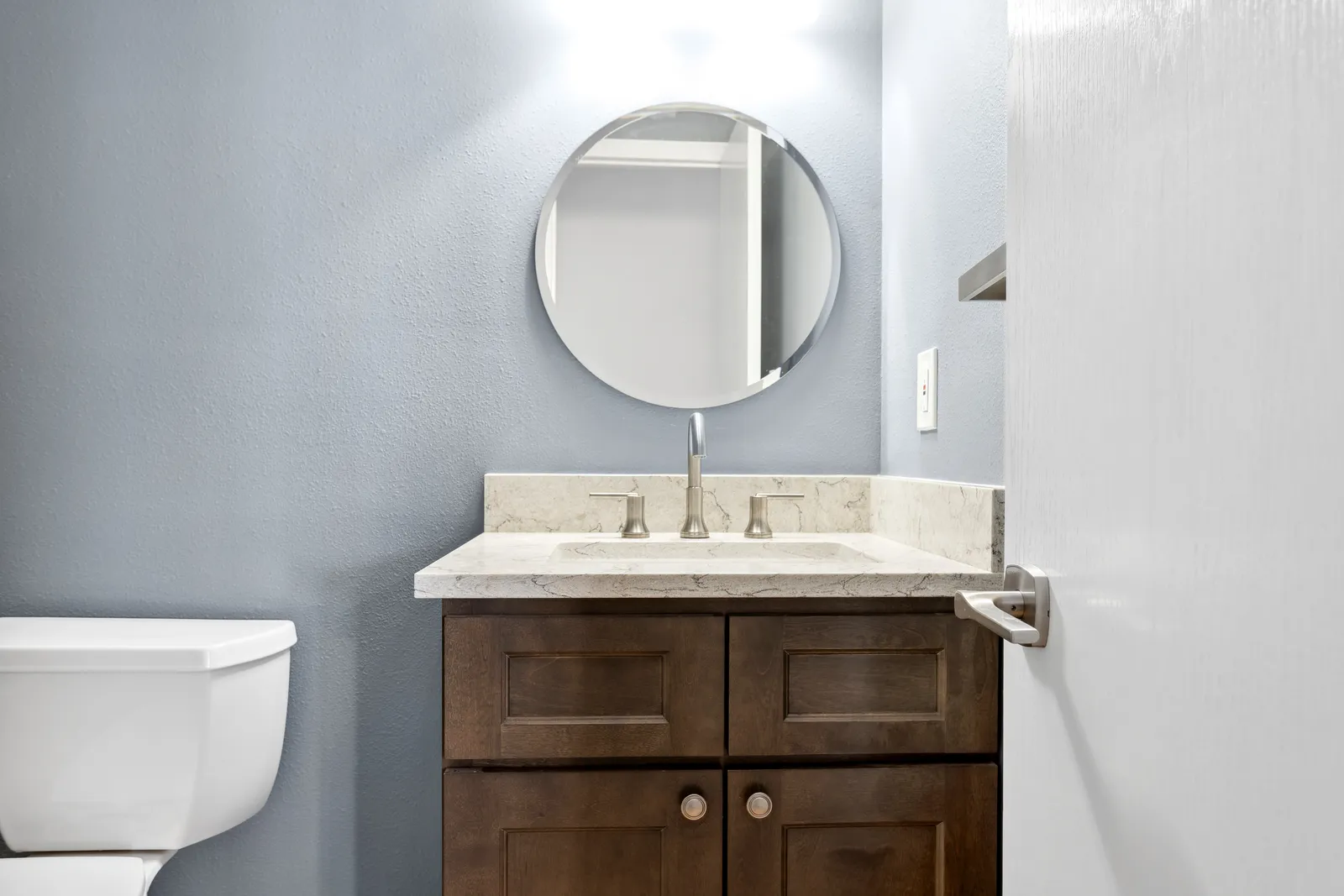 Powder room with marble-look counter and gray walls, Denver remodel