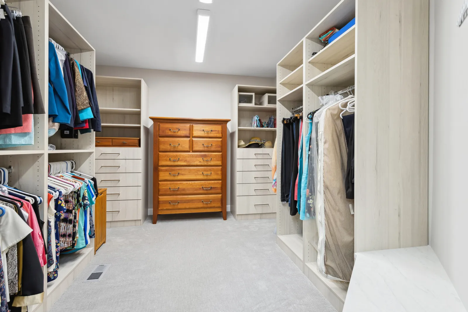 Custom walk-in closet with center dresser, Denver remodel
