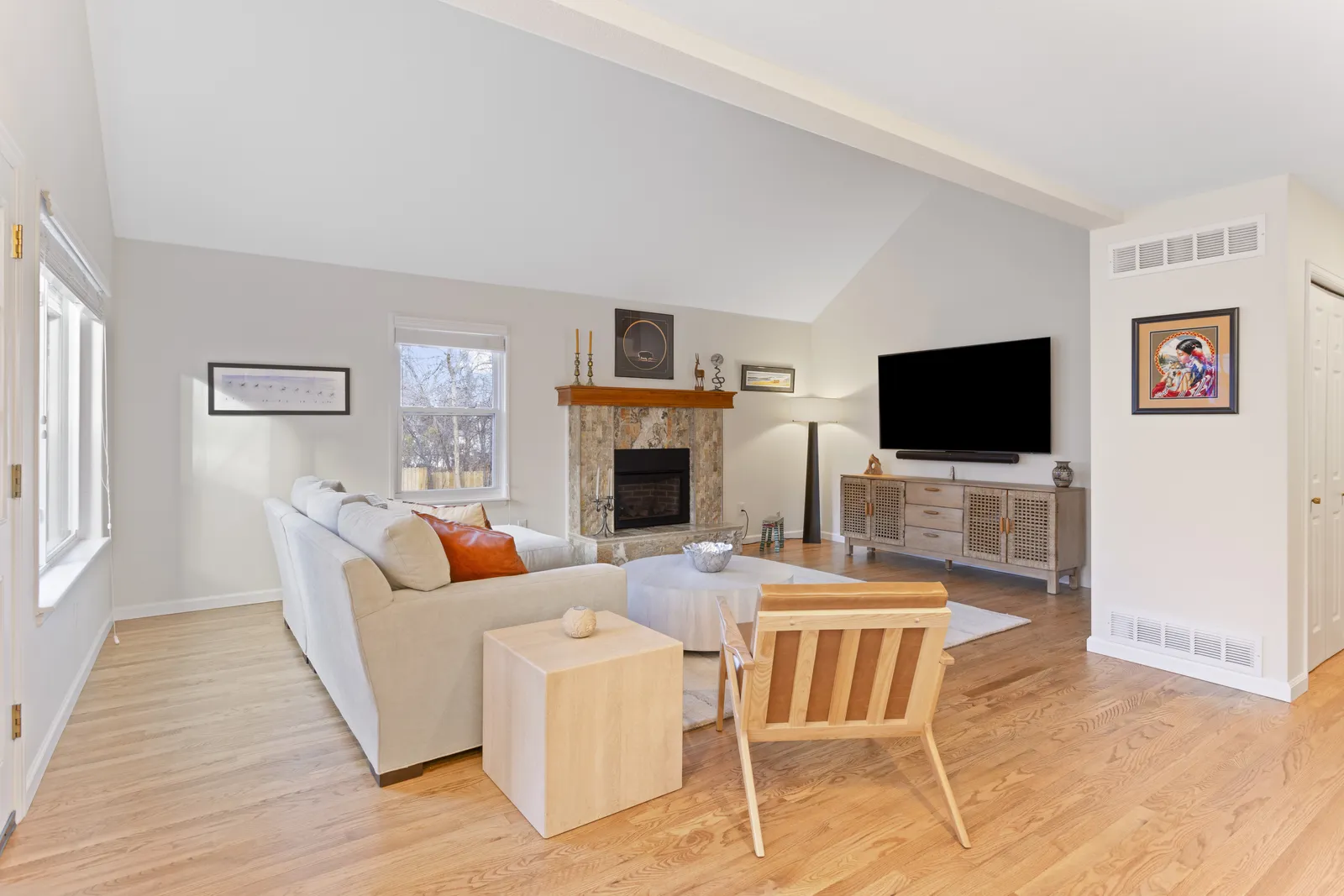 Open-concept living room with vaulted ceiling and fireplace, Englewood remodel